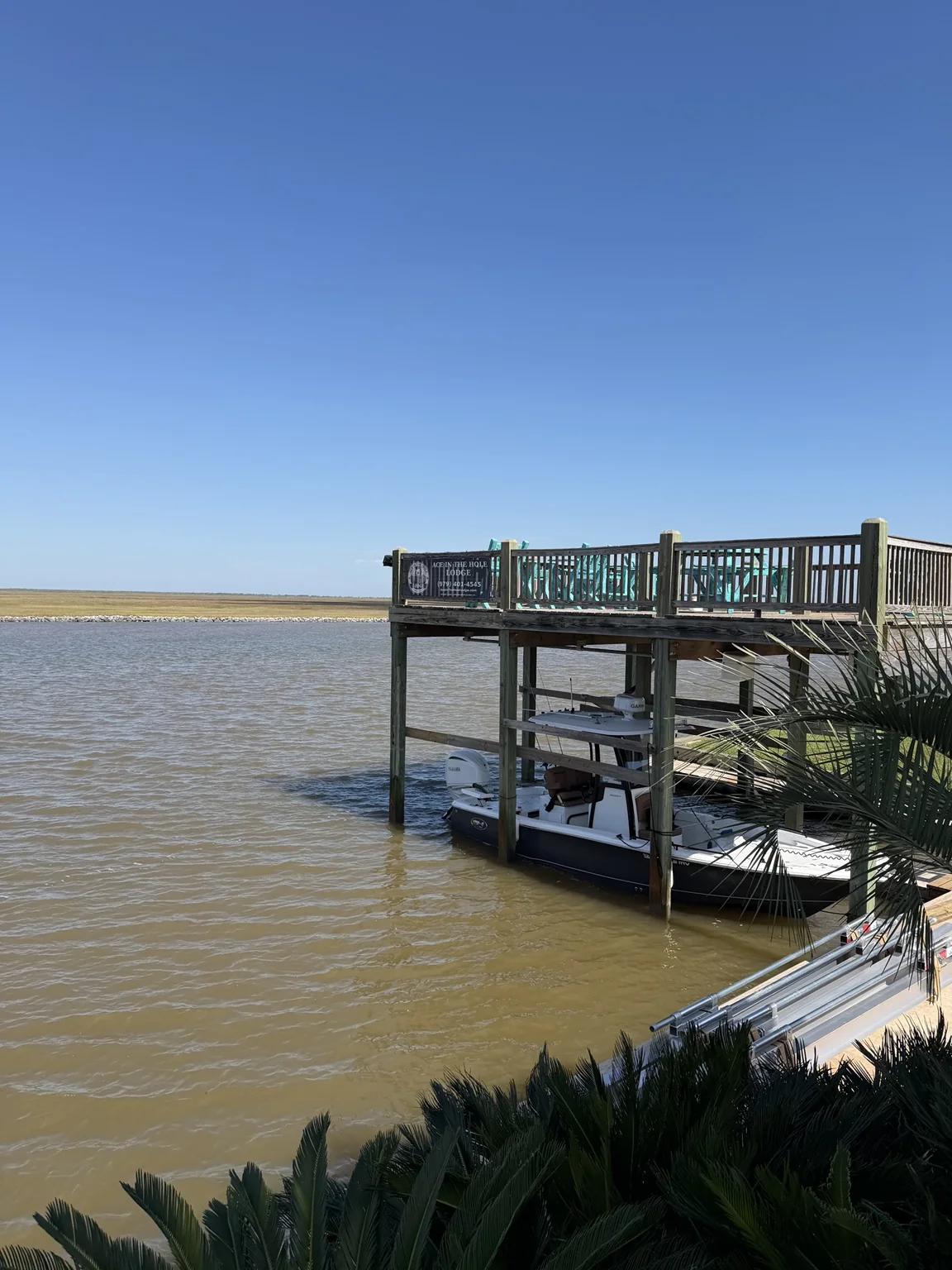 Boat at the lodge's two-slip dock across from the San Bernard National Wildlife Refuge
