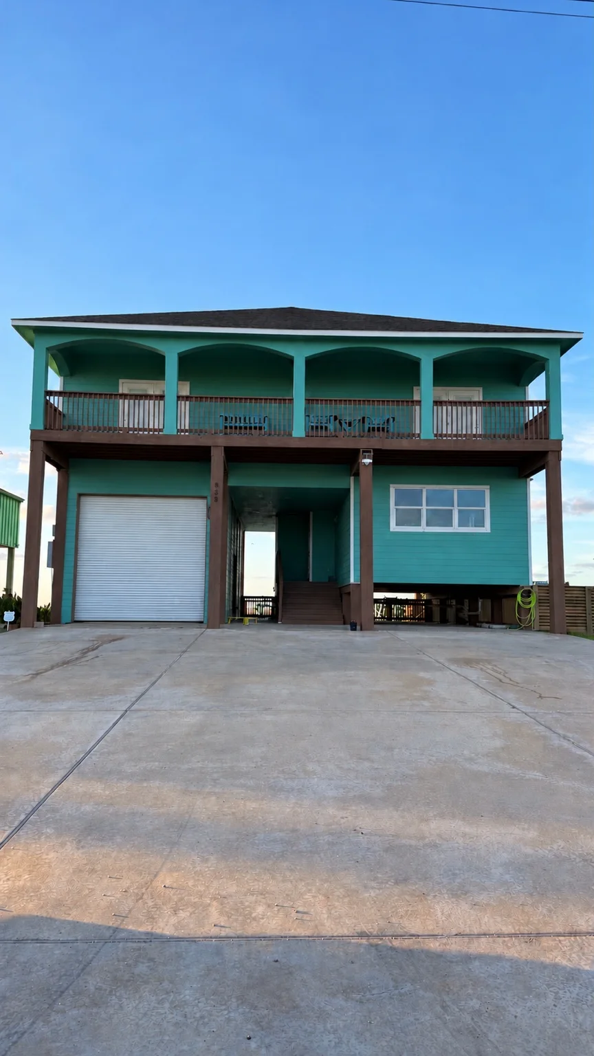 Front of Ace in the Hole Lodge with white garage door and upper balcony