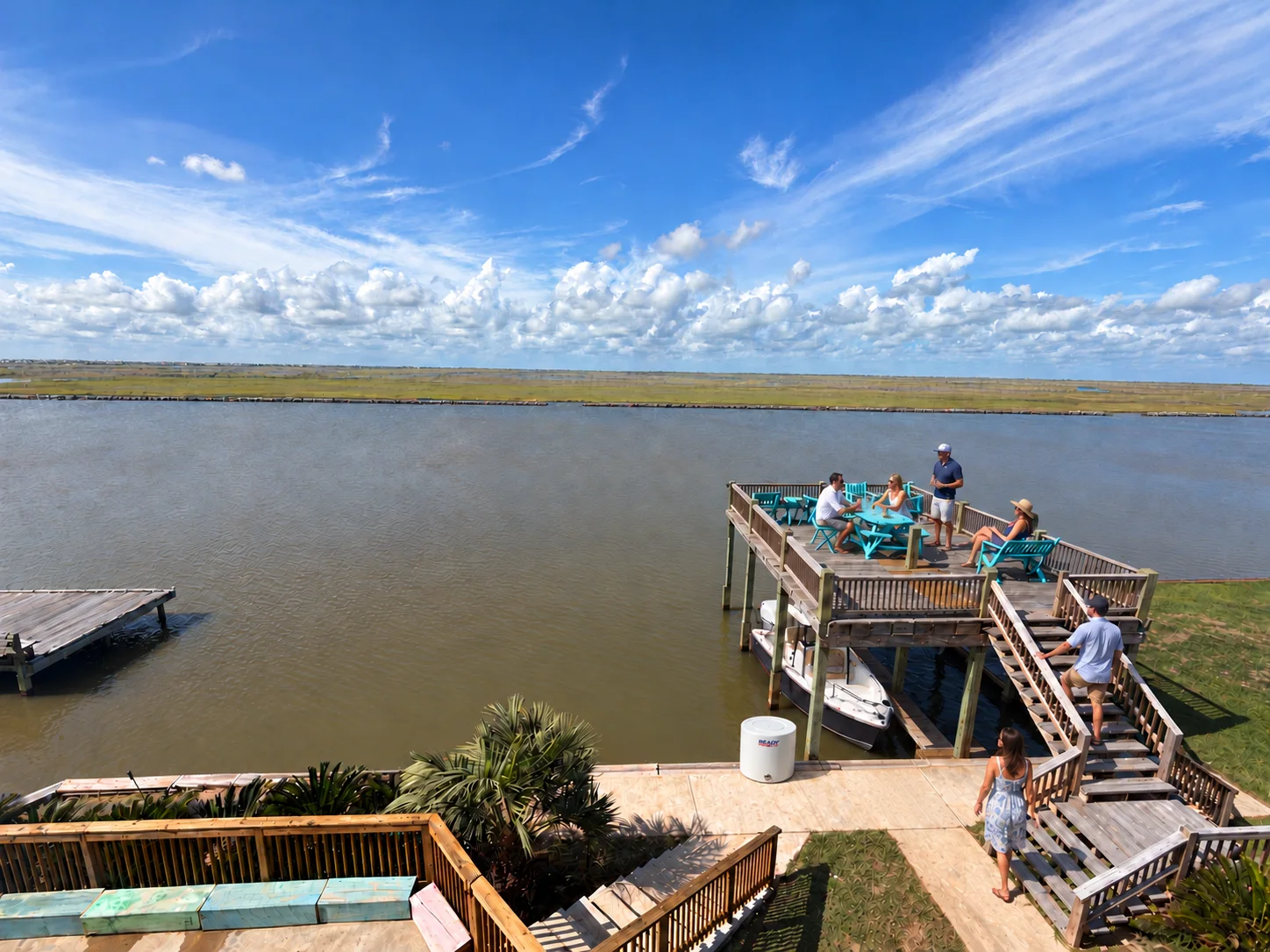 Illustrative guest gathering on the observation deck with the Sea Hunt in the boat slip